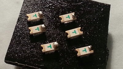 Double sided tape holding tiny components for soldering